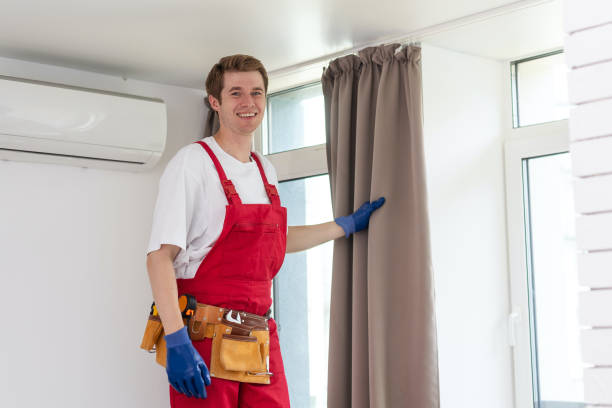 istock A male worker who installs a curtain. 1736877727