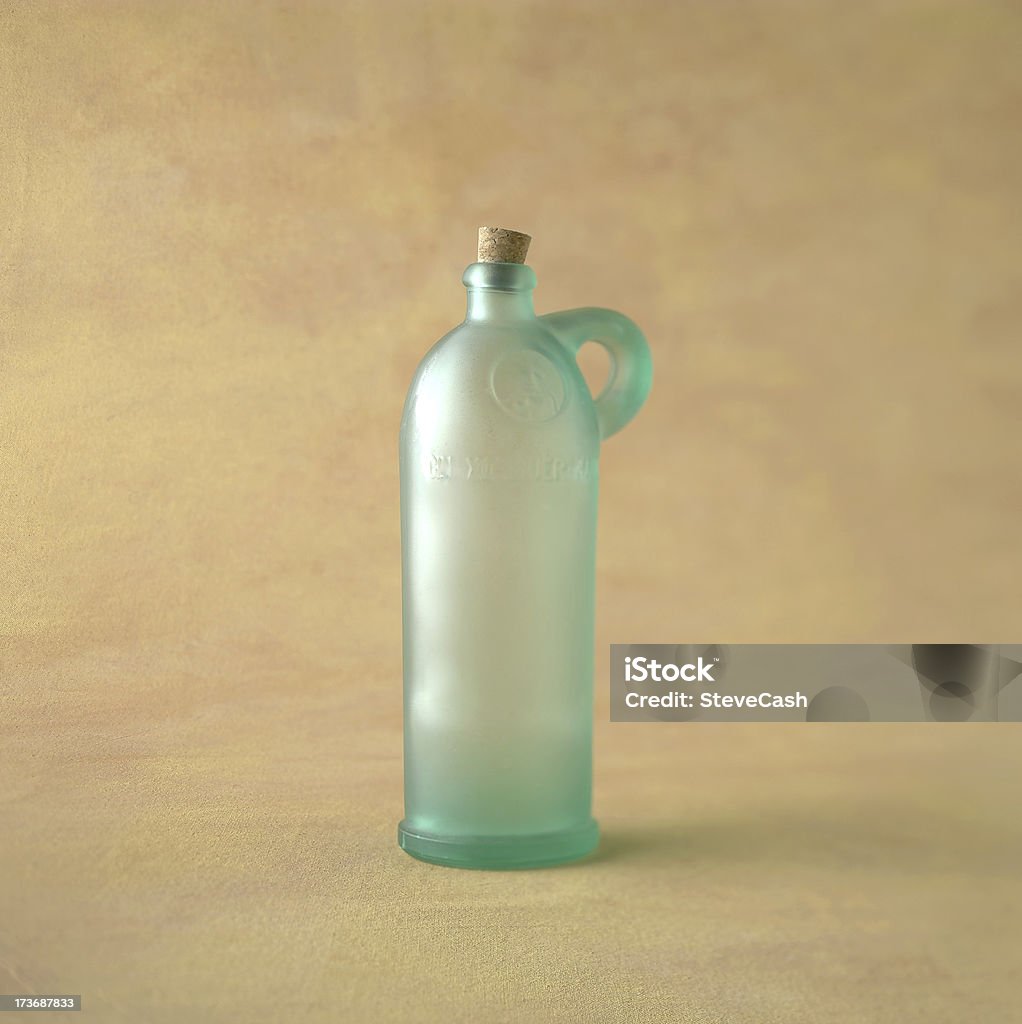 Green Glass Bottle on Canvas Green Bottle on Canvas with selective focus Canvas Fabric Stock Photo