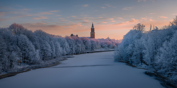 Frozen Aura river and Cathedral tower in Turku, Finland