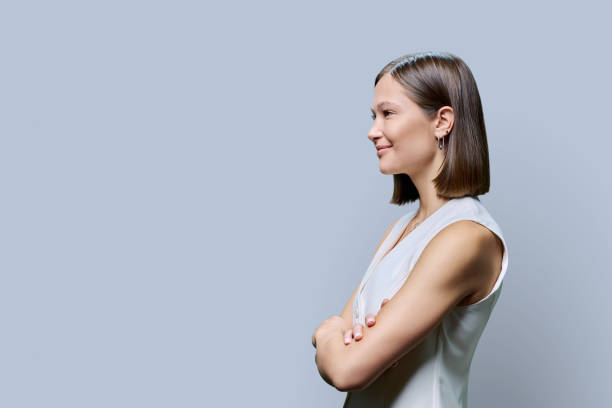 istock Profile view, confident young business woman, copy space gray studio background 1736903568