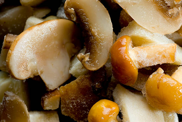 Frozen mushrooms thawing stock photo