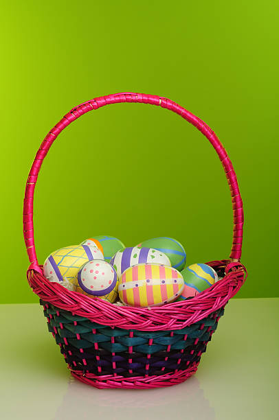 basket of colourful hand painted eggs stock photo