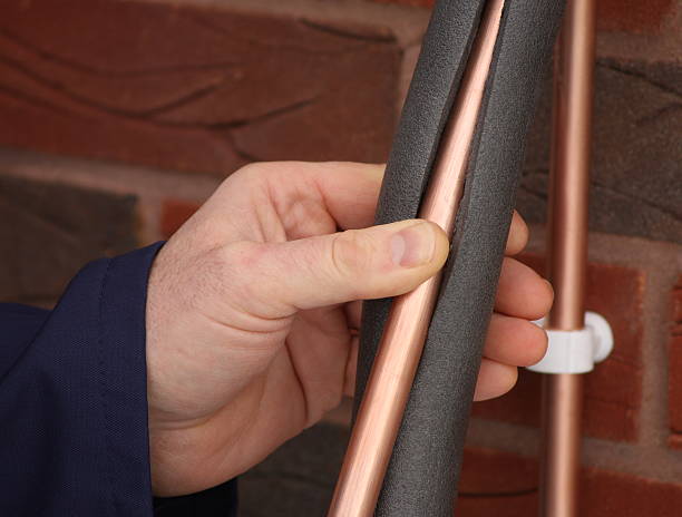 istock Plumber insulating a copper water pipe 173692828