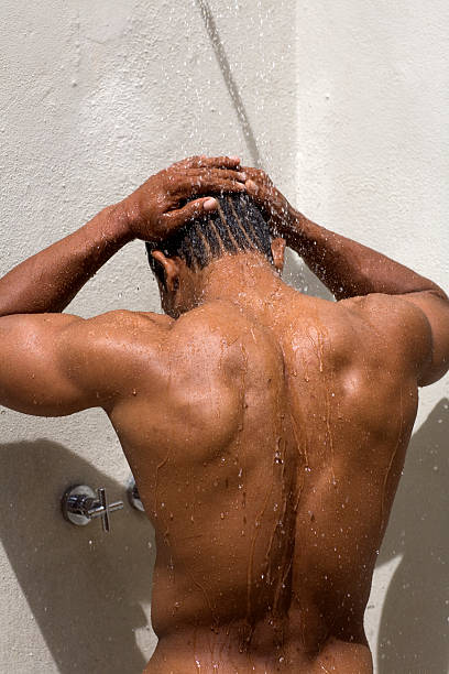 buff athlete showers rear view stock photo