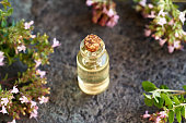 A bottle of thyme essential oil on a table