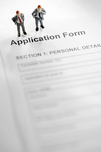 istock Mini Models of Businessmen on Application Form 173694686