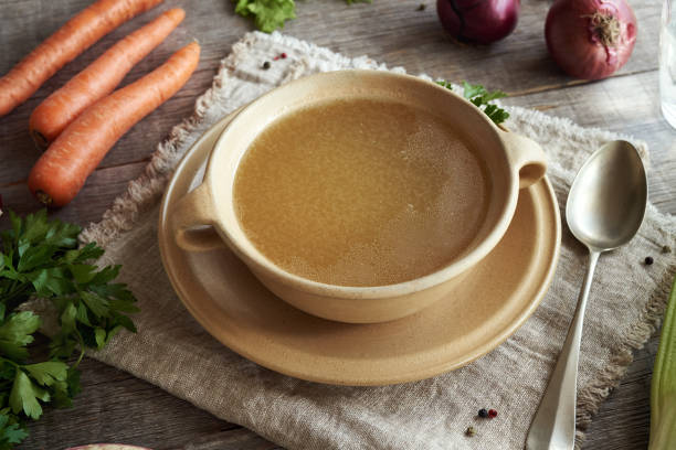istock Bone broth in a soup bowl with fresh vegetables on a table 1736959016