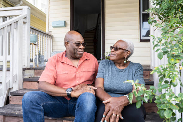 istock Relaxed senior Black couple sitting on front steps 1736960136