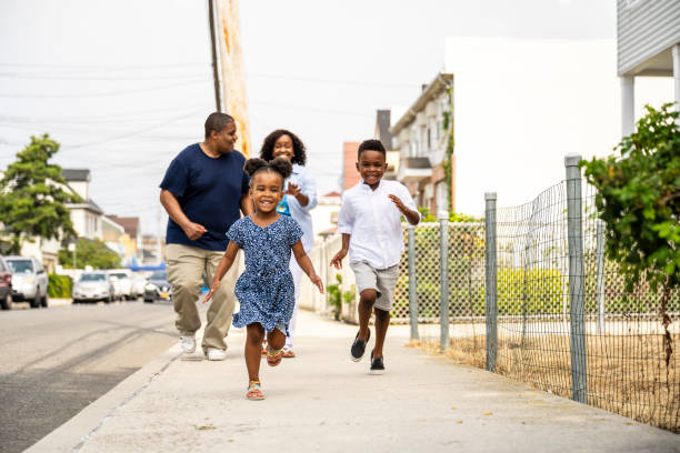 istock Young Black children and parents running for summer fun 1736960171
