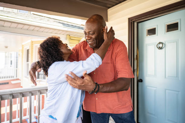 istock Family members embracing at front door 1736961268