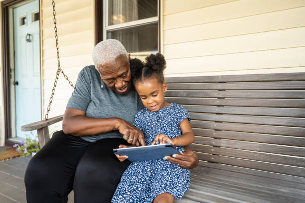 Grandmother and granddaughter using digital tablet