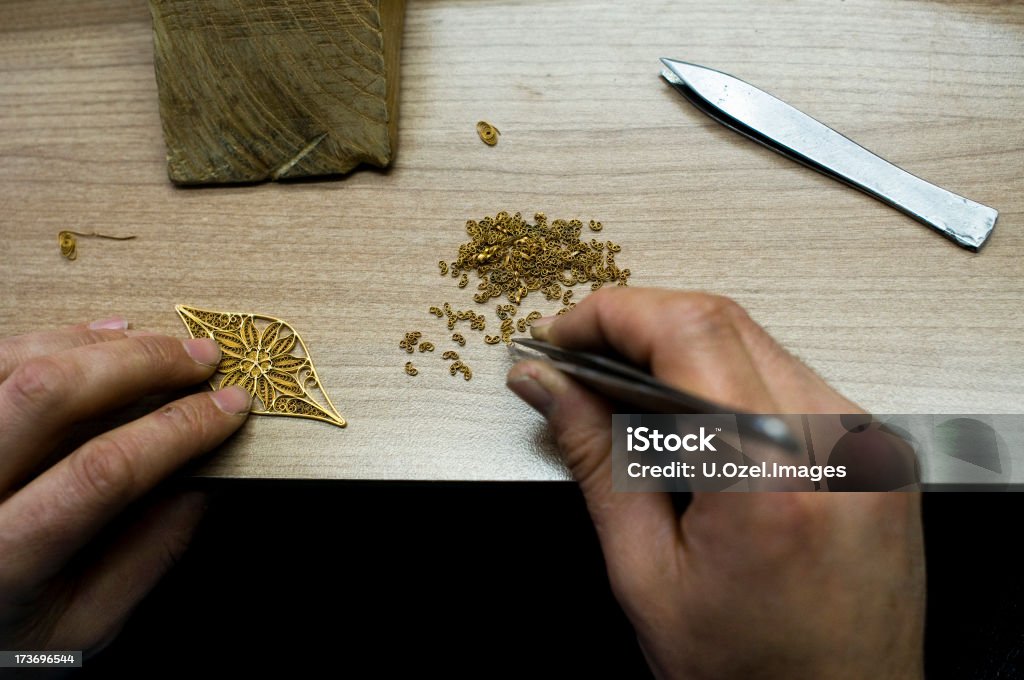 Craftsman working... An image from a jewelry studio... Design you see is anonymous and I think it's a well known style in Middle East... Adult Stock Photo