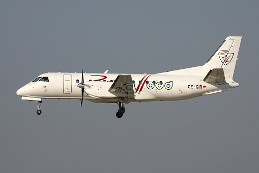 Oberglatt, Switzerland - June 28, 2011: Austrian Robin Hood Saab 340 with registration OE-GIR on short final for runway 14 of Zurich Airport.