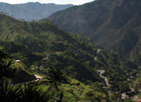 A winding mountain road thru the mountains and tropical forests of the Philippines.
