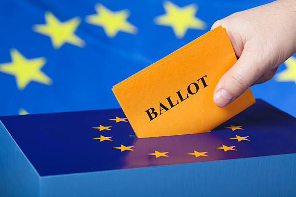 istock Male hand inserting ballot to EU ballot box 173698194