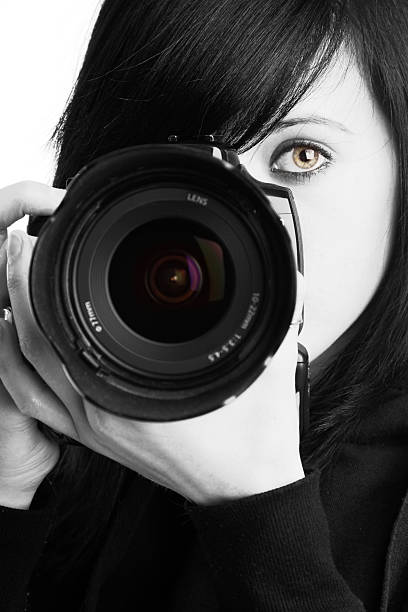 istock Female photographer in black and white holding a camera 173698455