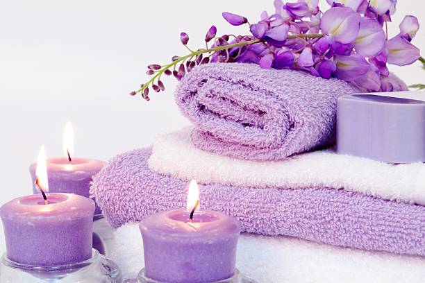 istock Spa Tranquility with purple towels, candles and flowers 173698559
