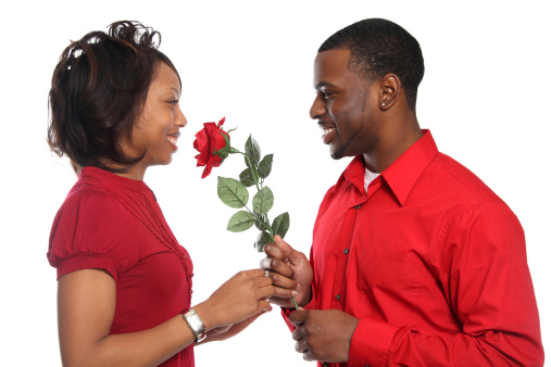 Young man presents his girlfriend with an artificial rose