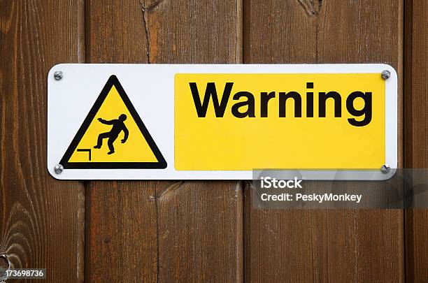 Warning Sign In Yellow With Falling Man Stock Photo - Download Image Now - Construction Industry, Construction Site, Trip Hazard Sign