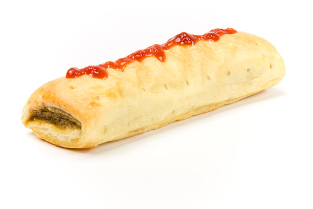sausage roll Sausage roll with tomato sauce. Isolated on white background. sausage roll stock pictures, royalty-free photos & images