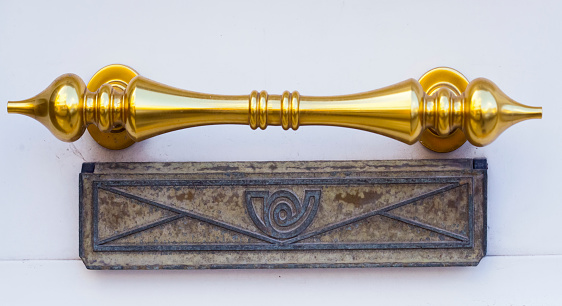 Antique brass drawer pull knob on concrete background. Copy space for text.