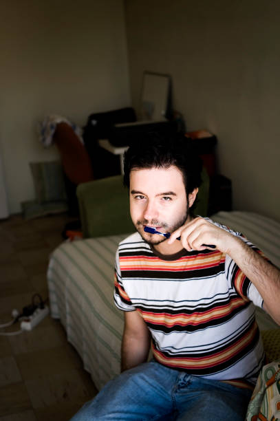 istock Young man with a tooth brush... 173699930