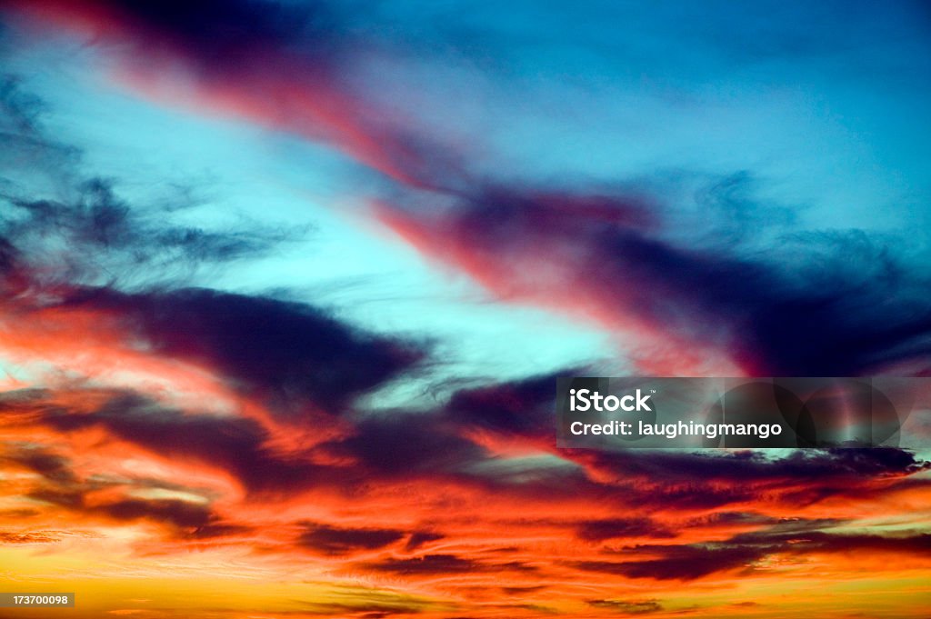 Orange clouds in a sunset against a blue sky colorful cloudscape sunset sky Above Stock Photo