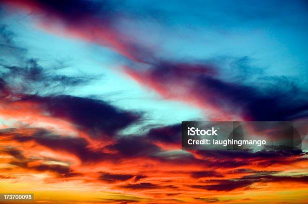 Orange Clouds In A Sunset Against A Blue Sky Stock Photo - Download Image Now - Above, Backgrounds, Beauty In Nature