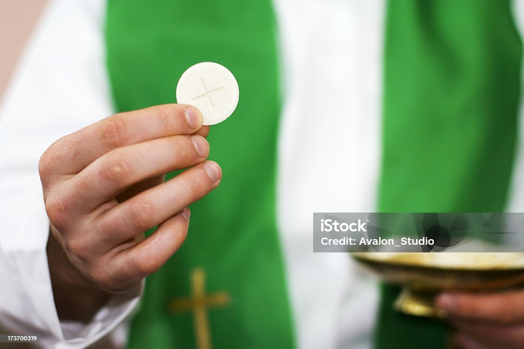 Priest of communion in the hand Communion and clergyman. Communion Stock Photo