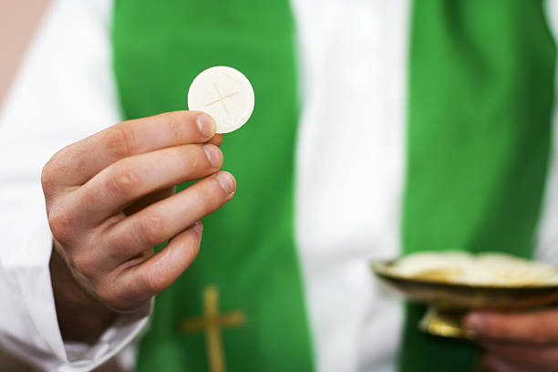 Priest of communion in the hand stock photo
