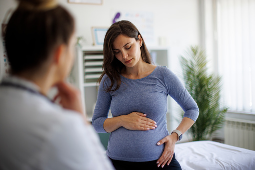 Shot of a worried pregnant woman having a consultation with a doctor