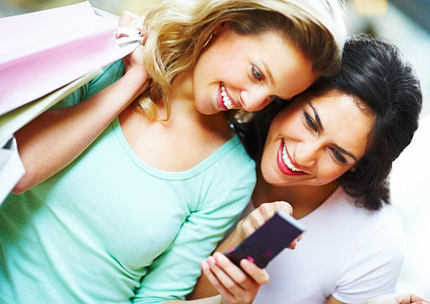 istock Two young women looking at cellphone and smiling 173701148