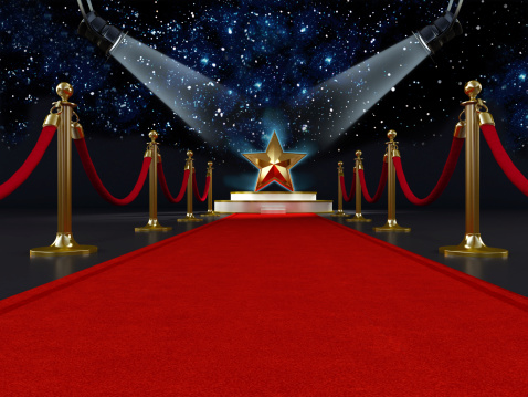 Red carpet with a star shape on the platform lit by two spotlights.Similar images: