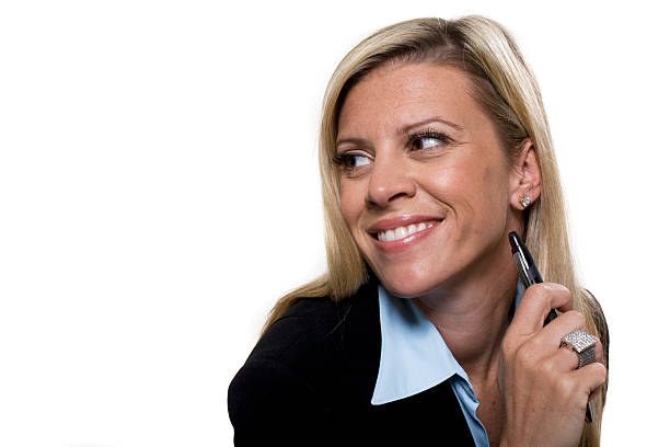 Smiling businesswomen holding pen stock photo