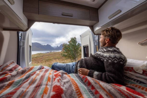 istock Road trip- Man in his camper van relaxing on the bed 1737045177