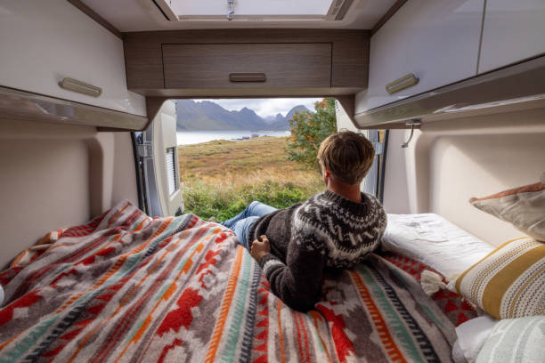 istock Road trip- Man in his camper van relaxing on the bed 1737046265