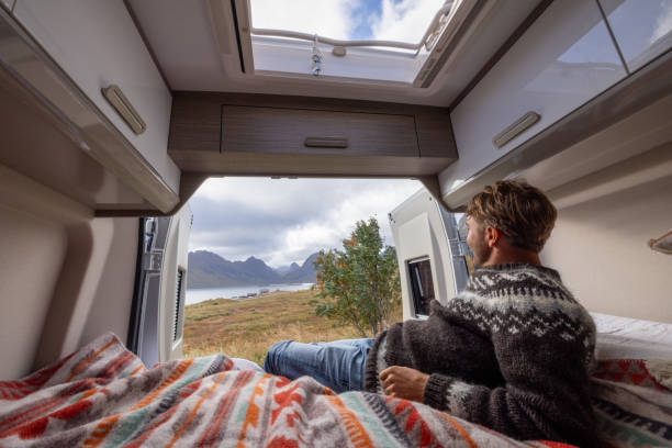 istock Road trip- Man in his camper van relaxing on the bed 1737047463