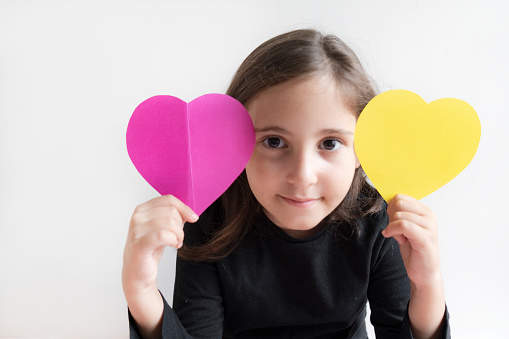 Cute little girl with a paper heart shape
