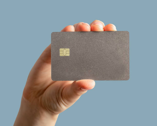 istock Hand holding plastic bank card mock up, debit with chip 1737095174