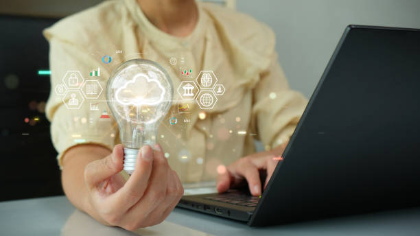istock Woman holding light bulb with cloud icon. Digital technology concept, data sheet management with large database capacity and high security. Storage transition from computer to cloud computing. 1737099336