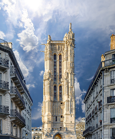 Saint-Jacques Tower (Tour Saint-Jacques) against the background of a beautiful sky with clouds. Located on Rivoli street, Paris, France. This 52 m Flamboyant Gothic tower (XVI century)