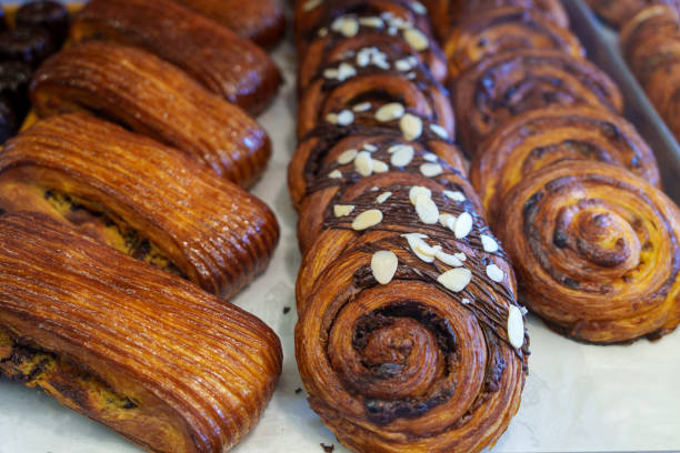 istock Various freshly baked pastries and croissants are displayed in a bakery store 1737107244