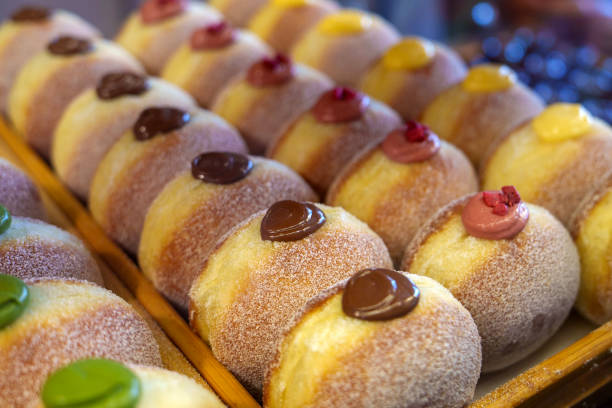 Creamy donuts displayed on a tray in a bakery store