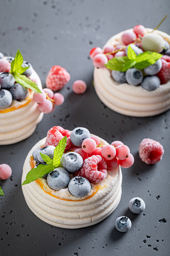 Creamy mini Pavlova dessert with frozen berries and meringue. Pavlova dessert with frozen blueberries and raspberries.
