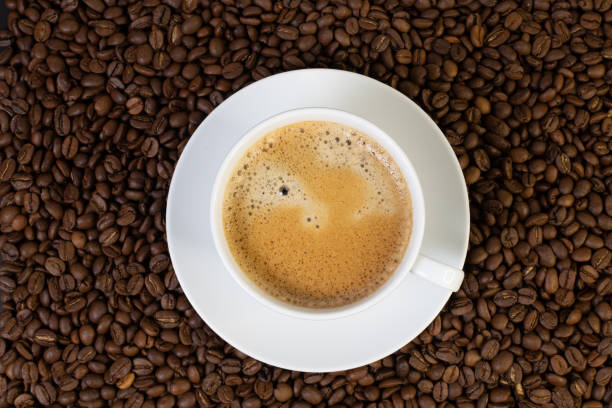 istock white cup with coffee on a background of Arabica beans 1737144221