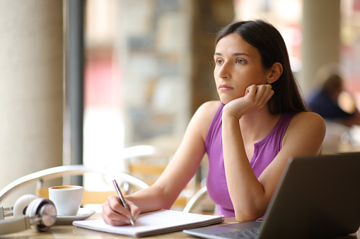 Demotivated student looking away in a restaurant