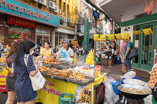 Vegetarian Festival (J Festival) In Thailand at Yaowarat Bangkok China town, Street food kiosk decoration yellow flag sign for no meat ingredient food. 14 October 2023. Bangkok, THAILAND.