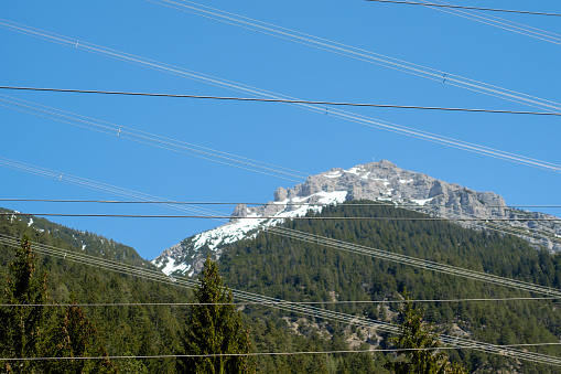 Überlandleitungen kreuz und quer durch Alpenlandschaft