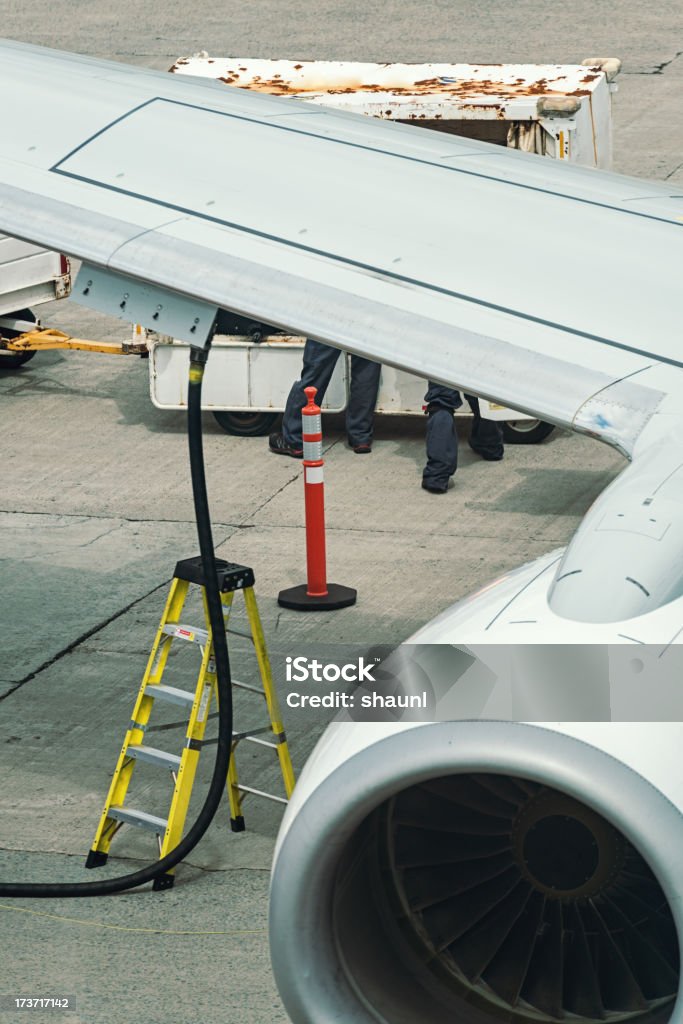 Refueling Jet A passenger jet is refueled and unloaded at an airport gate. Aerospace Industry Stock Photo