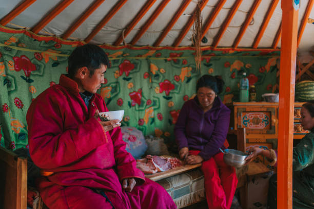 istock Mongolian man enjoying goat milk tea inside yurt with his family 1737179538